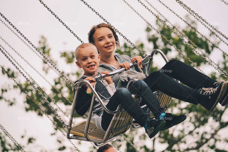 Two children in crousel swings