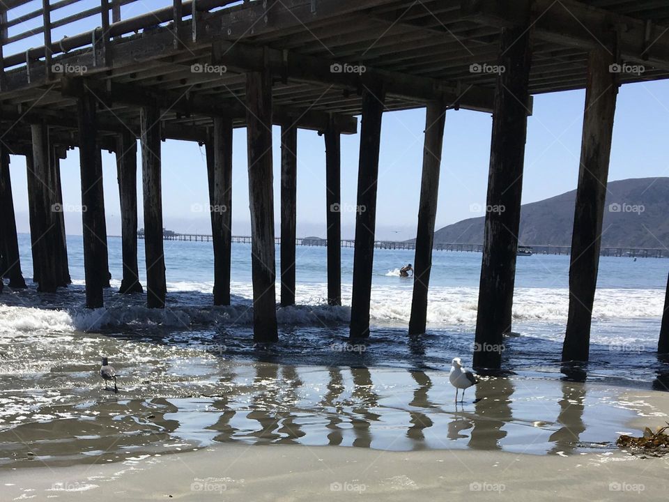 A lazy sunny California summer day under a pier on the coast.