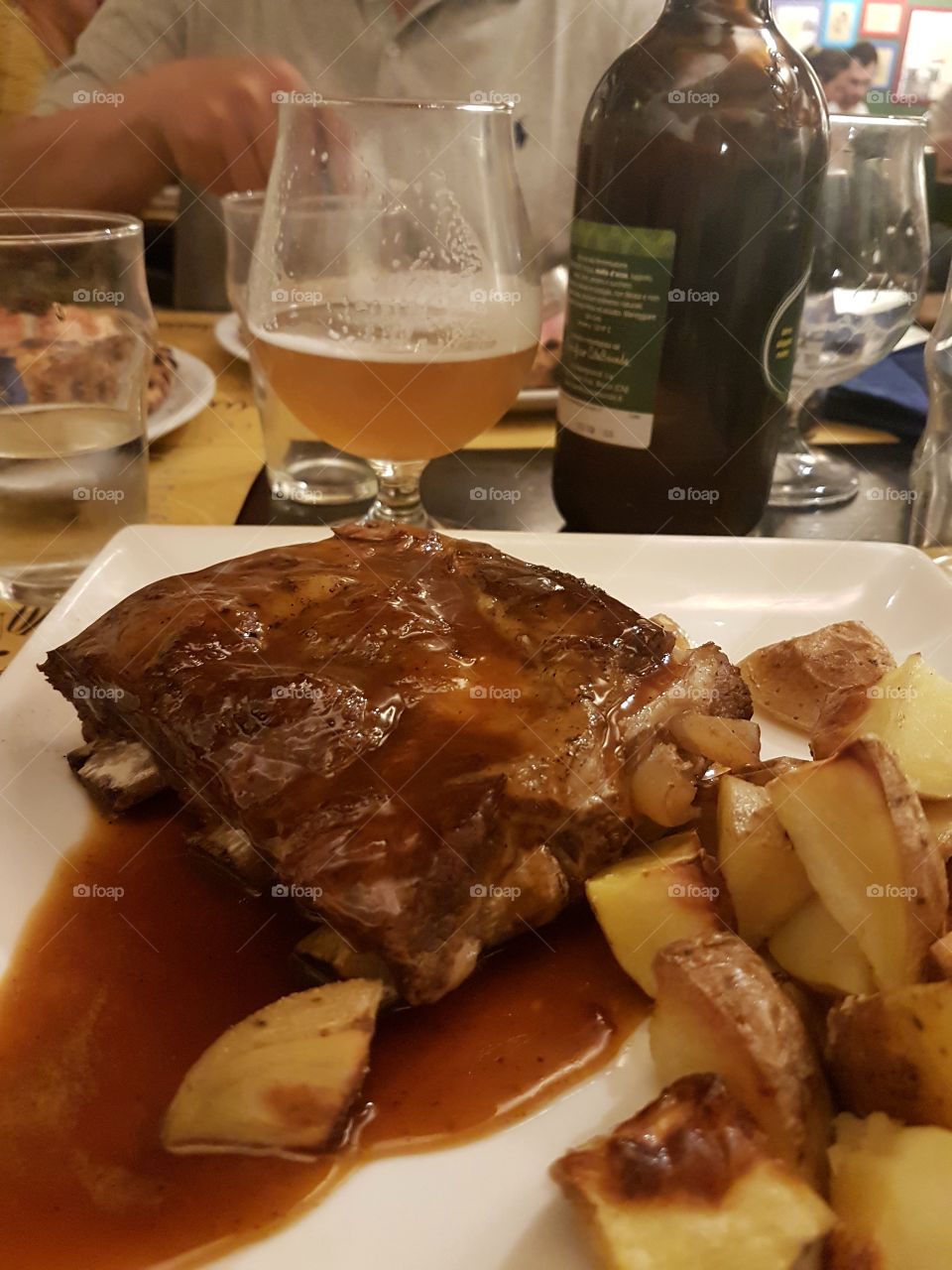 Baked Pork ribs with potatoes and a glass of beer