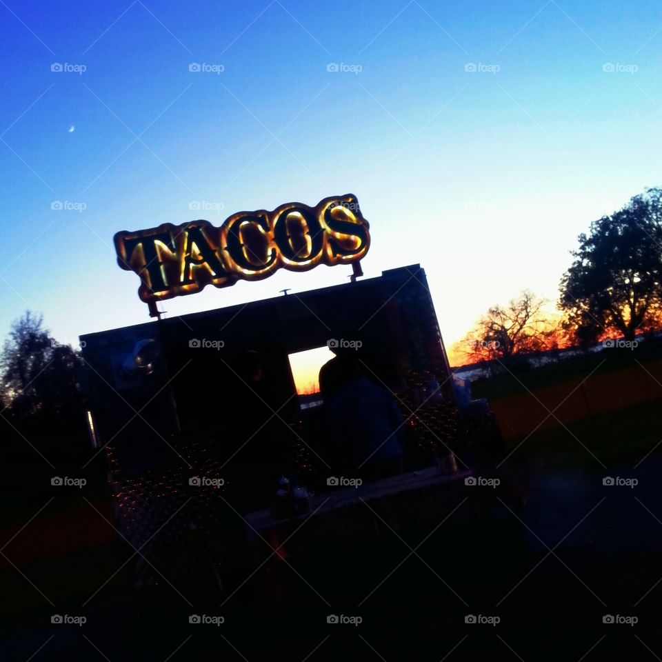 taco sign at dusk