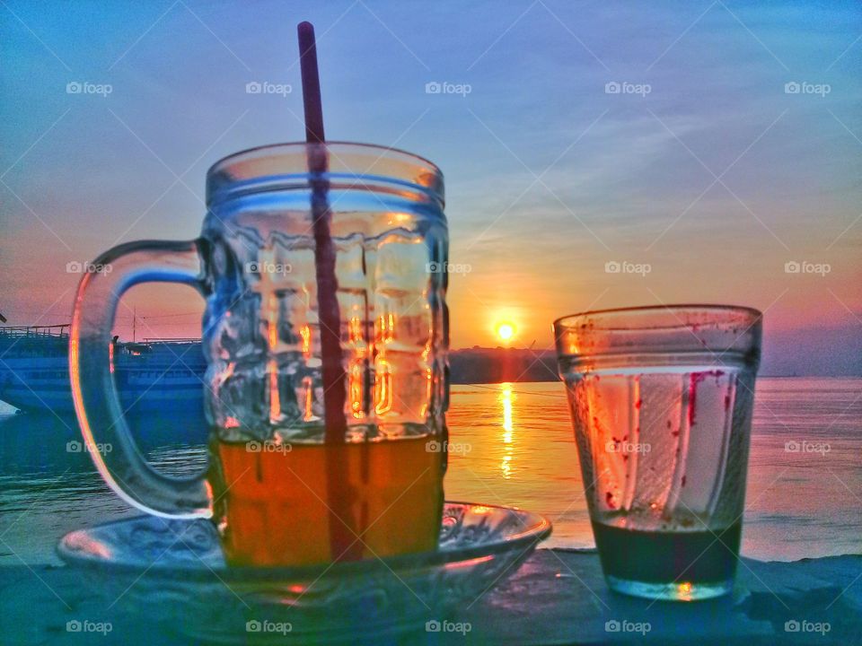 glass and coffie  at sunset