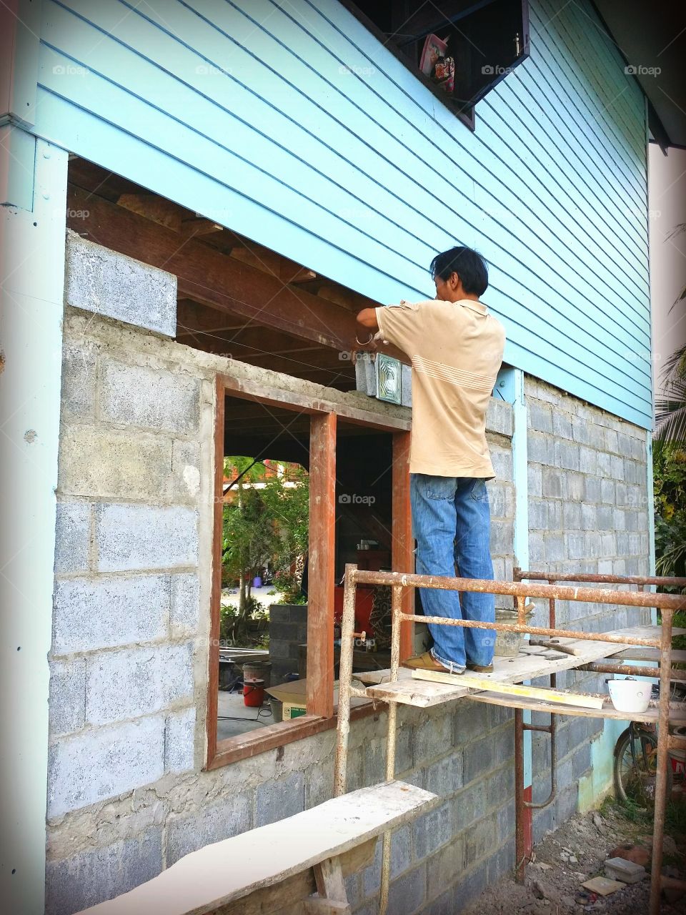 Working.. Construction workers working on a house.