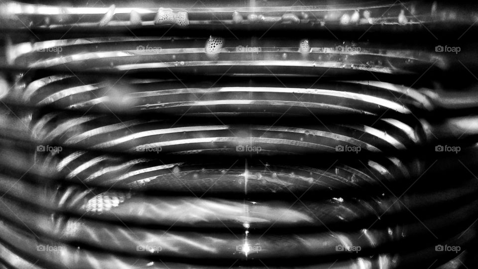 Bending lines in a coffee cup in a café in black and white, abstract feeling and the sense of it being a cage