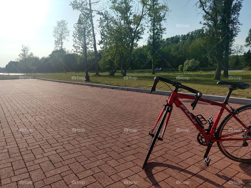 red road bicycle on brick sodewalk