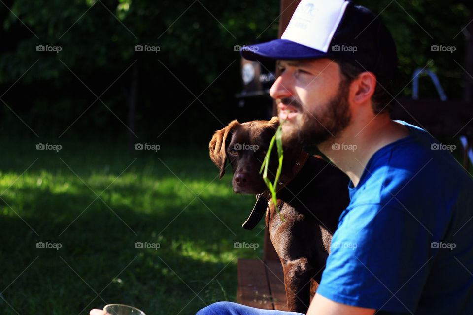 Men with a dog. Hanging out with a pet
