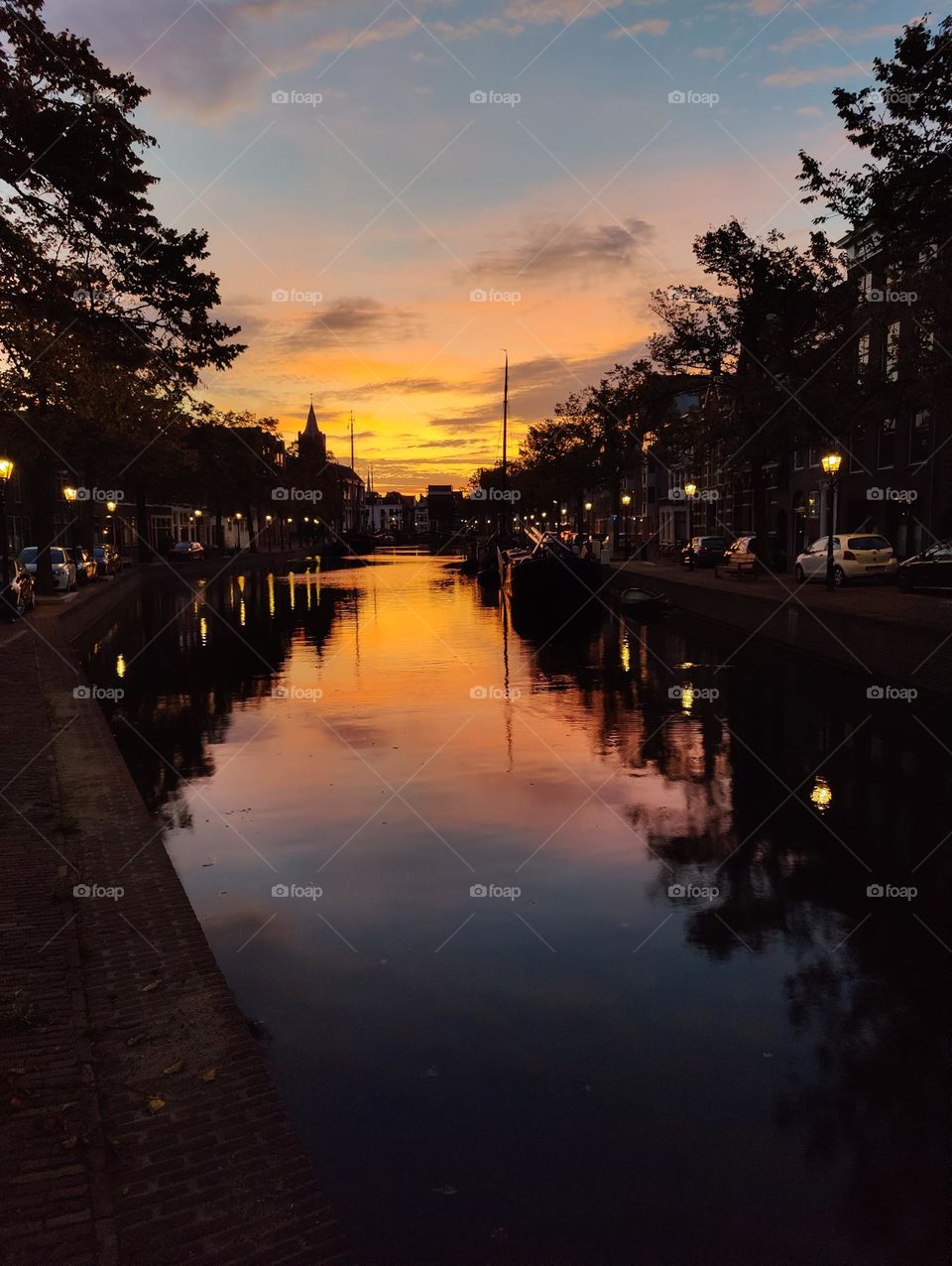 Colorful yellow and orange sunrise in the harbour of Schiedam