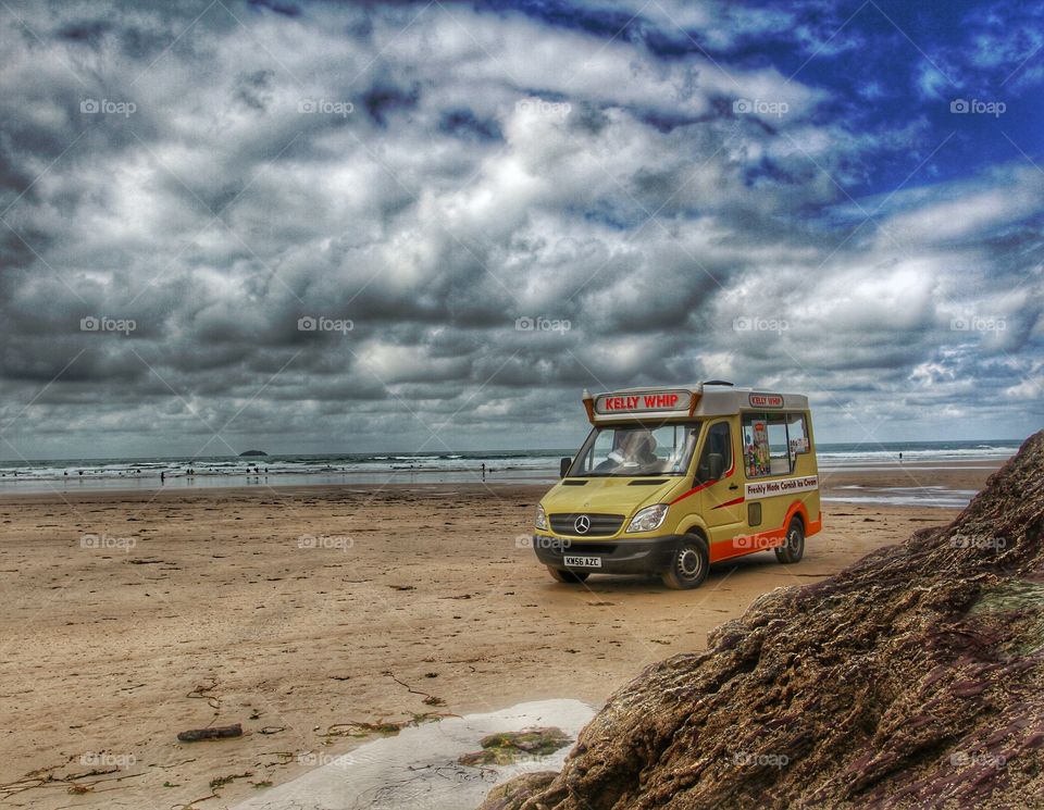 A Cornish Ice Cream van on a vast beach in Cornwall.