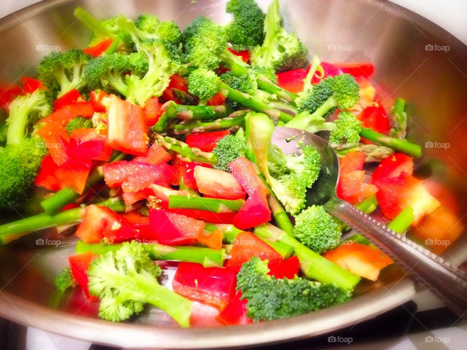 Veggie stir fry. Colorful vegetables being stir fried in a pan