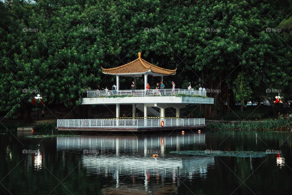 People are standing on board to enjoy the view of lake