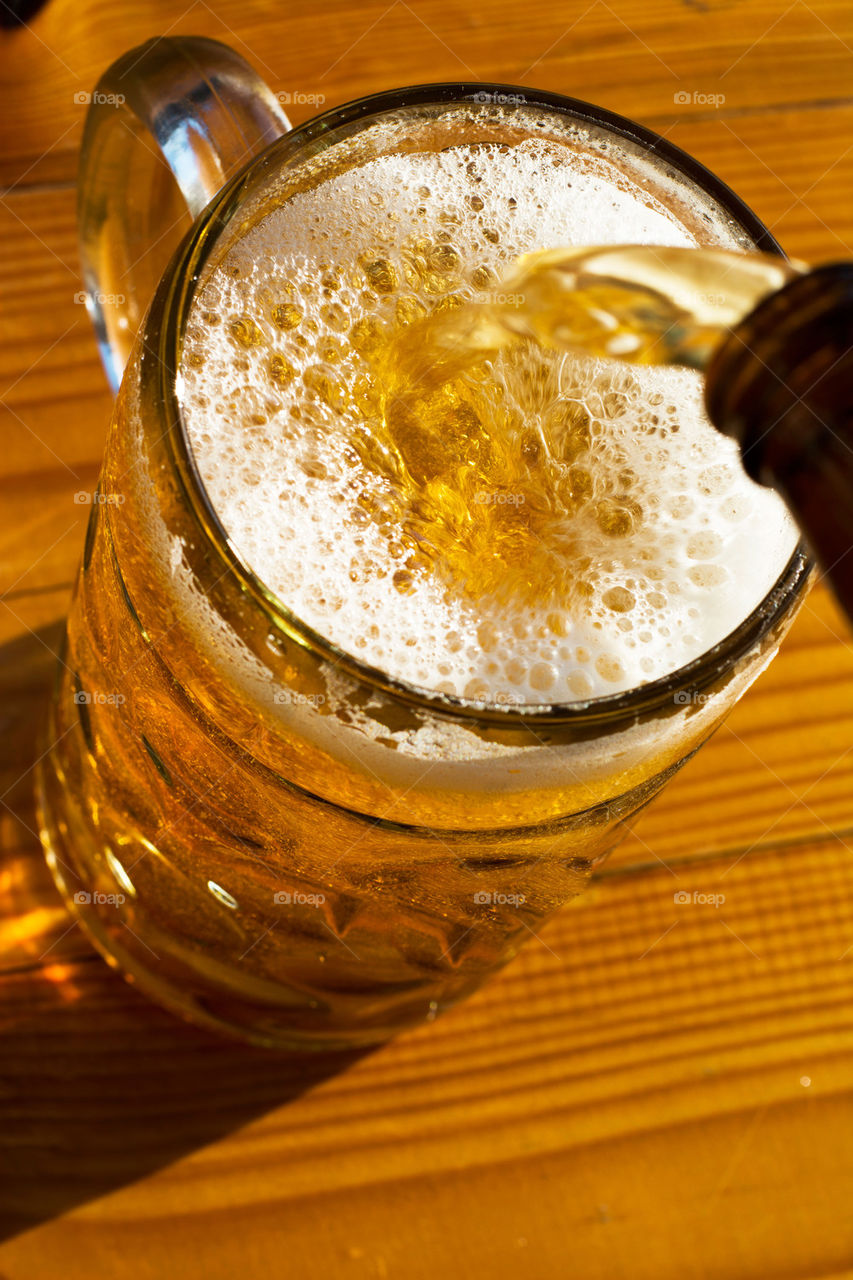 pouring beer into big mug