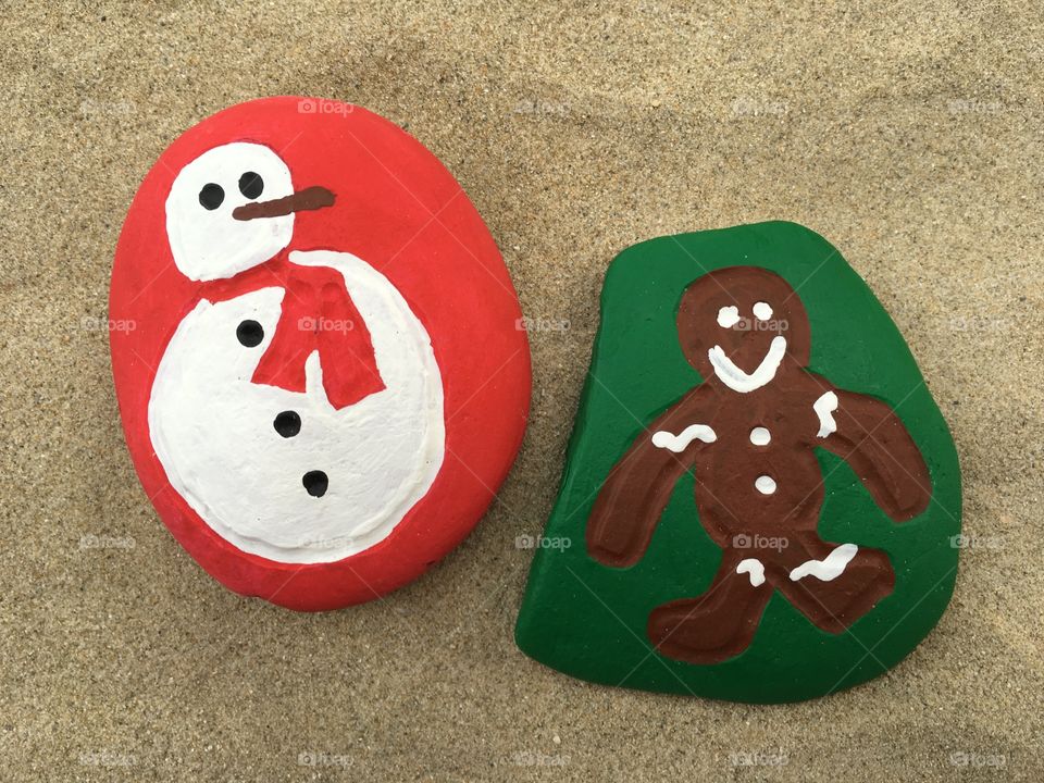 Christmas symbols, ginger bread and snowman on stones