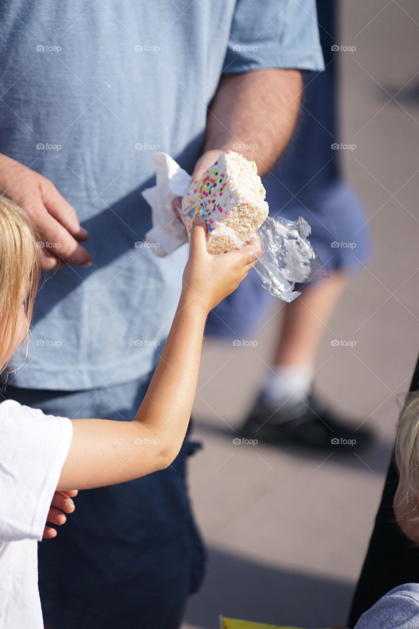 Close-up of man sharing candy with girl