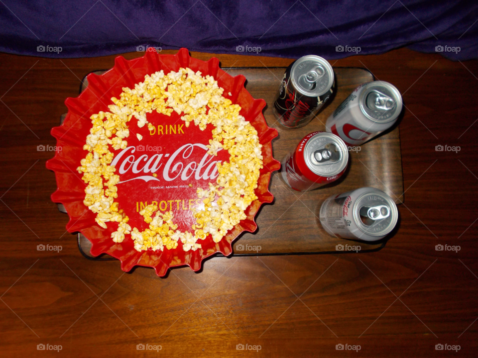 Coke-Cola bottle cap bowl with popcorn and empty cans