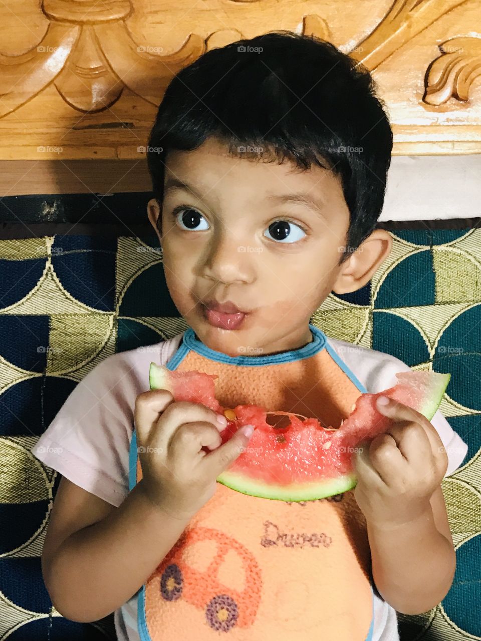 Indian baby boy eating watermelon 