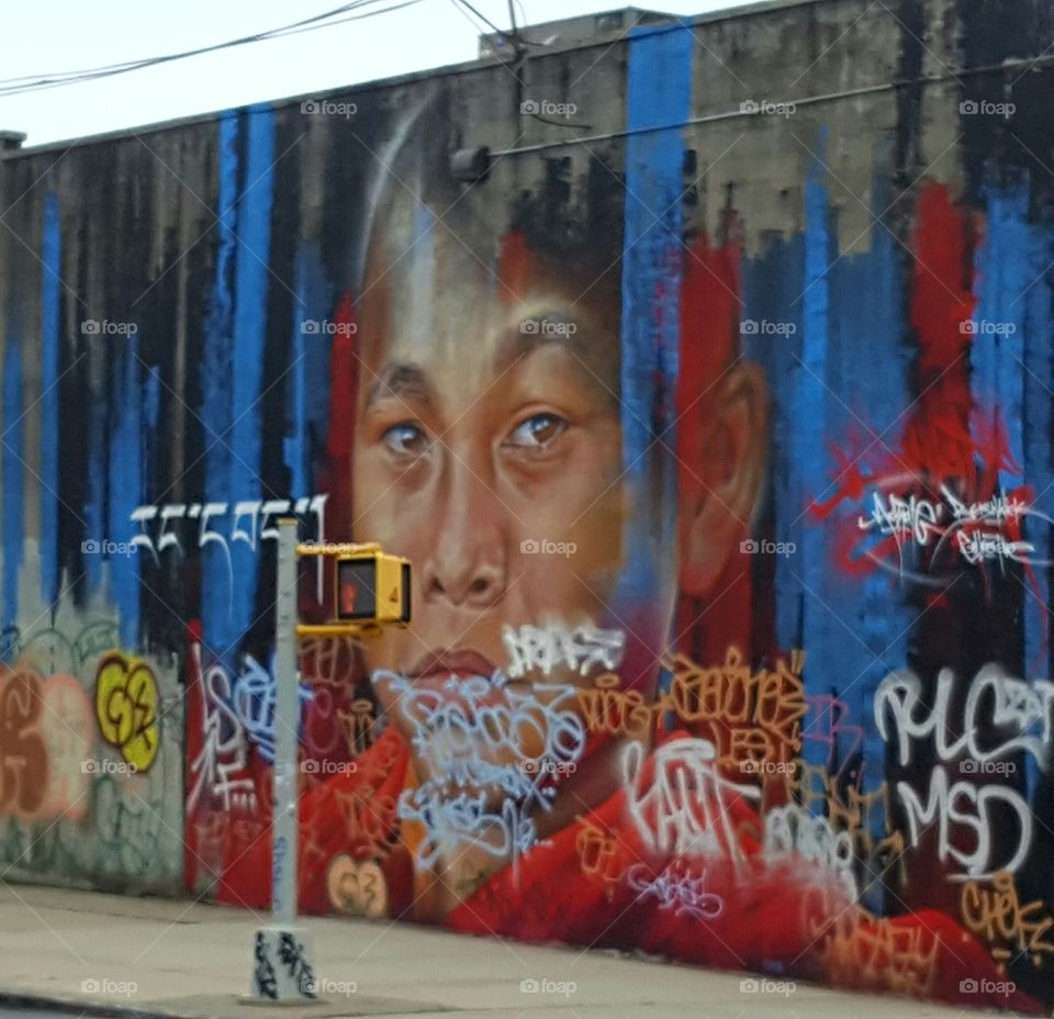 graffiti portrait on side of building