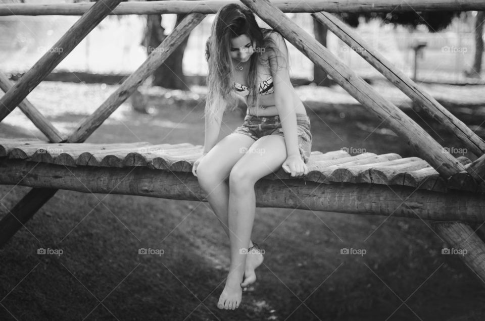 Woman sitting on wooden pier
