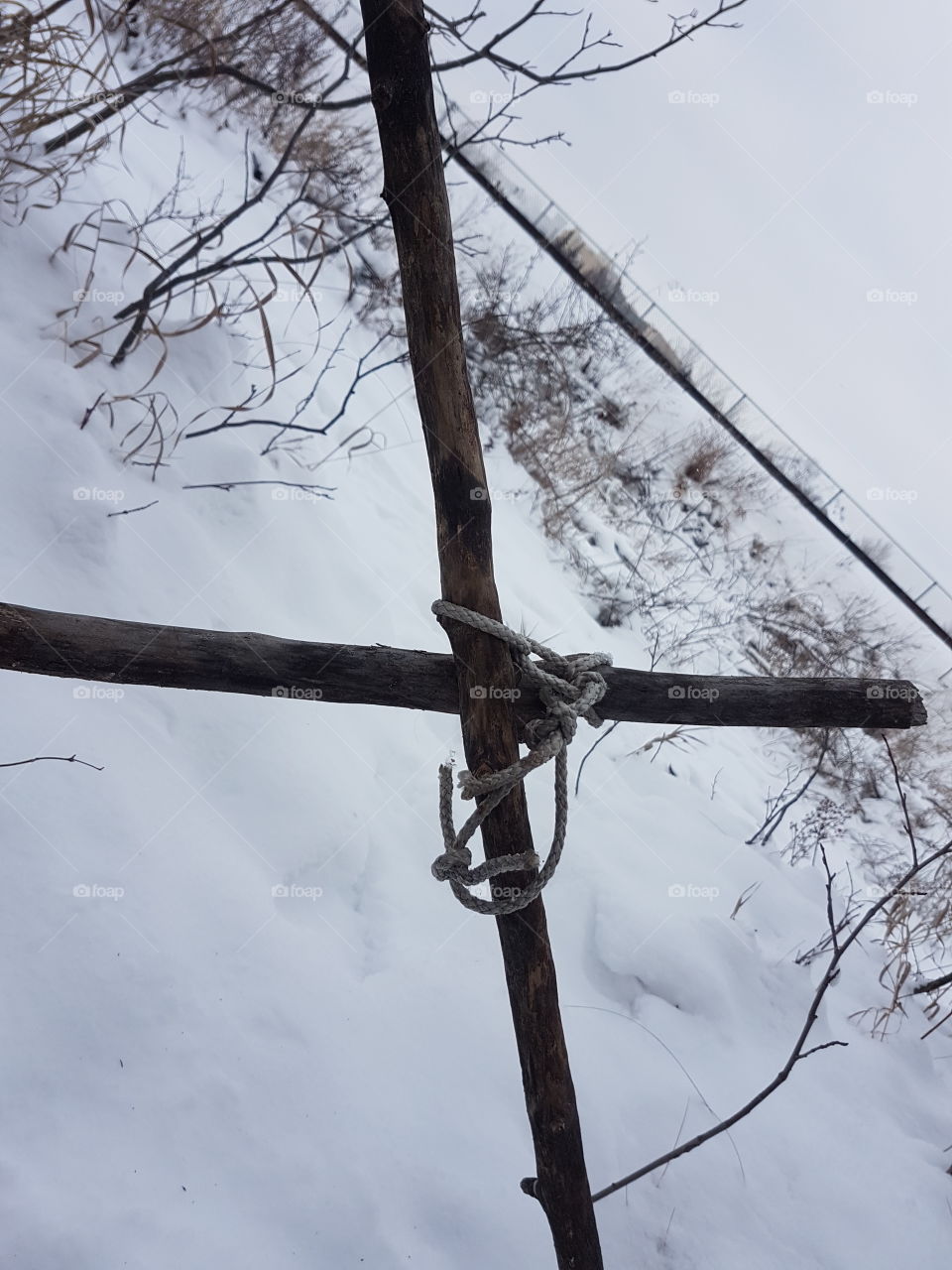 makeshift cross on a trail
