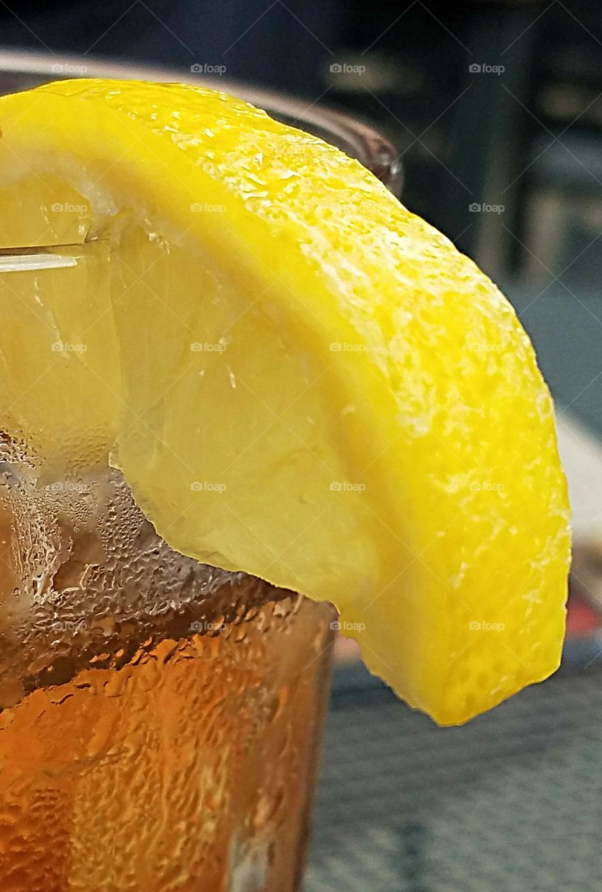 lemon slice on a glass of iced tea