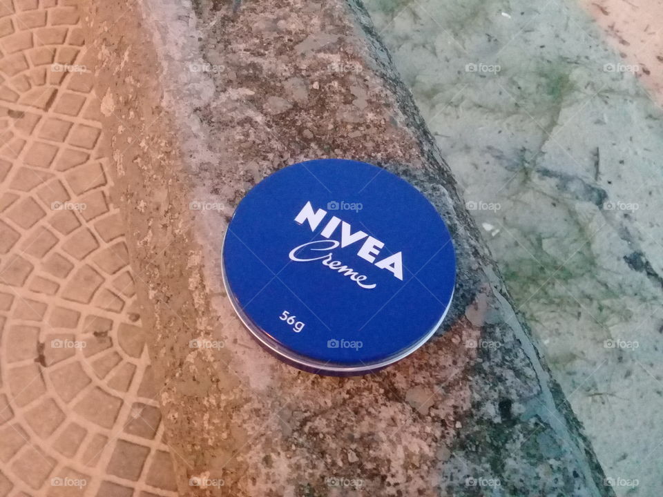 Nivea creme by the beach. Care and happiness