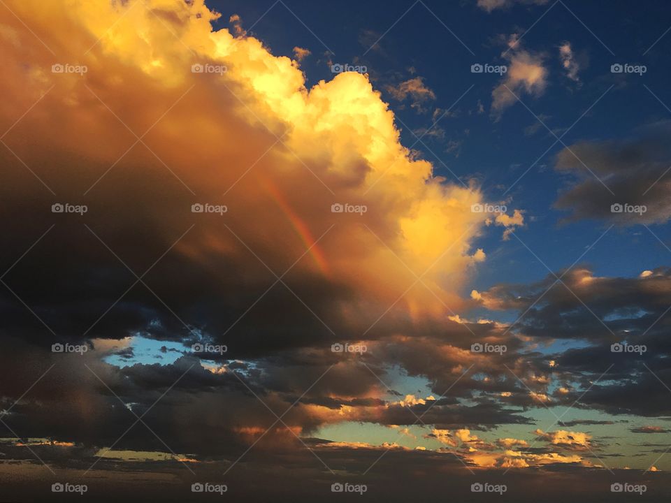 Rainbow through a storm cloud at sunset in south Australia 