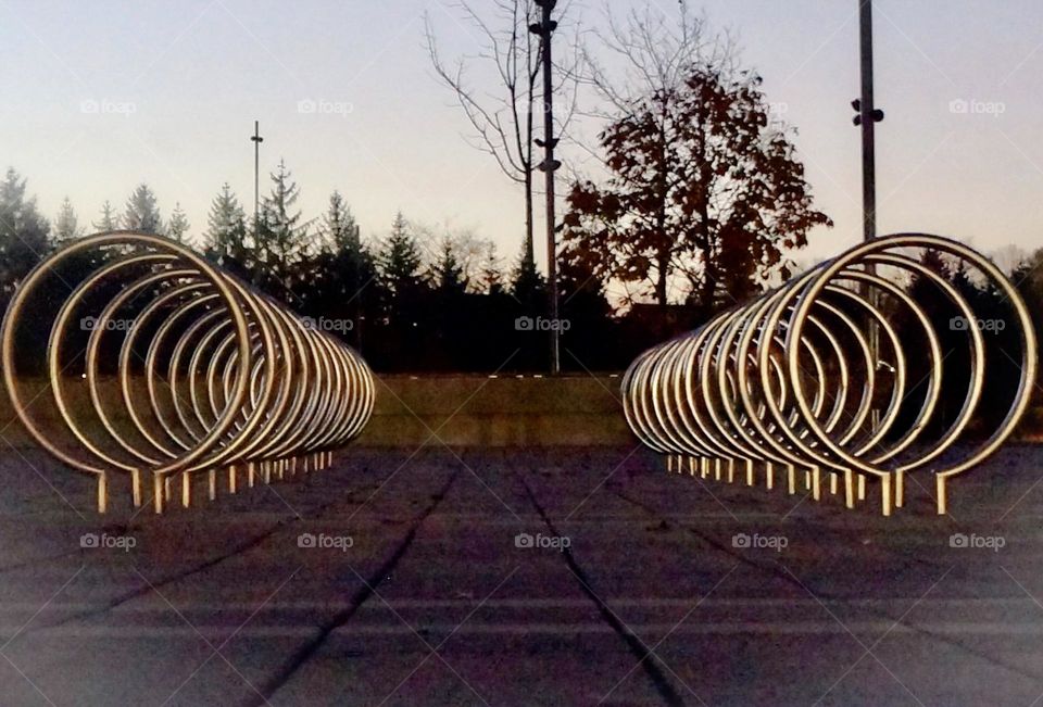 Parallel bike racks at dawn.