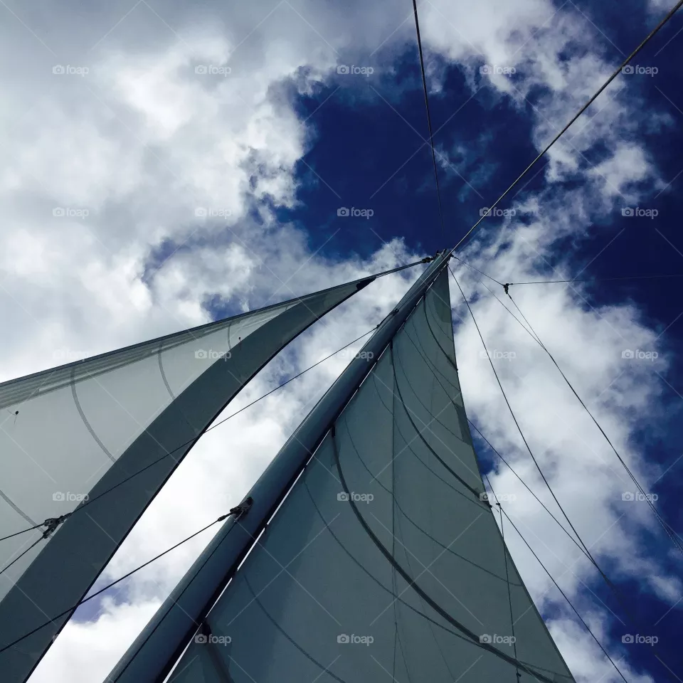 Looking up in sky . From catamaran ship blue sky and clouds in San Juan 