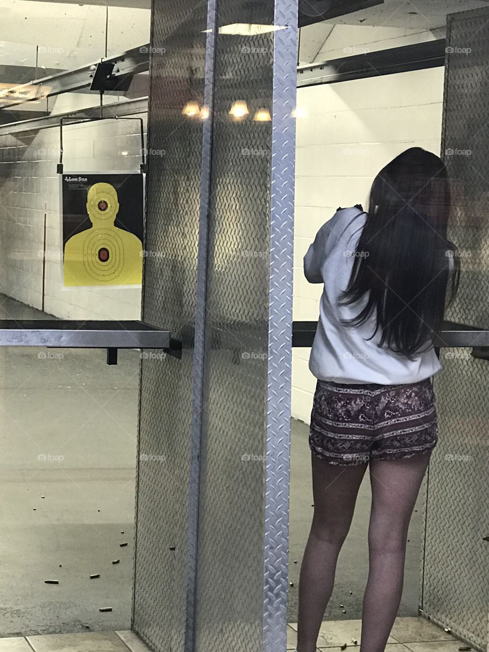 Young woman shooting at a shooting range