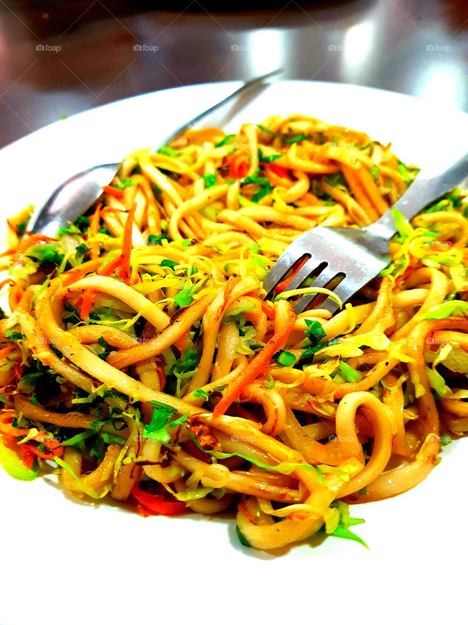 Travel the world and enjoy cuisines FROM different country. The noodle here is the one available in Bhutan. It is called "CHOW MEIN". Ingredient include noodle, onion, chilli, tomato, salt, oil, coriander, carrot and turmeric powder.