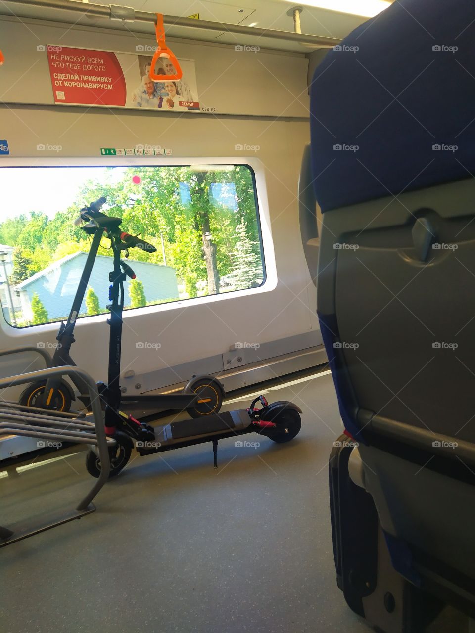 Two electric scooters on the background of a window in a subway train carriage