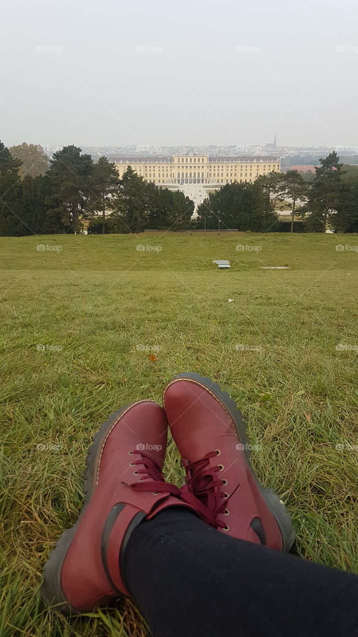 red boots on green grass of Schönbrunn Palace. Winter in Europe, Vienna.
