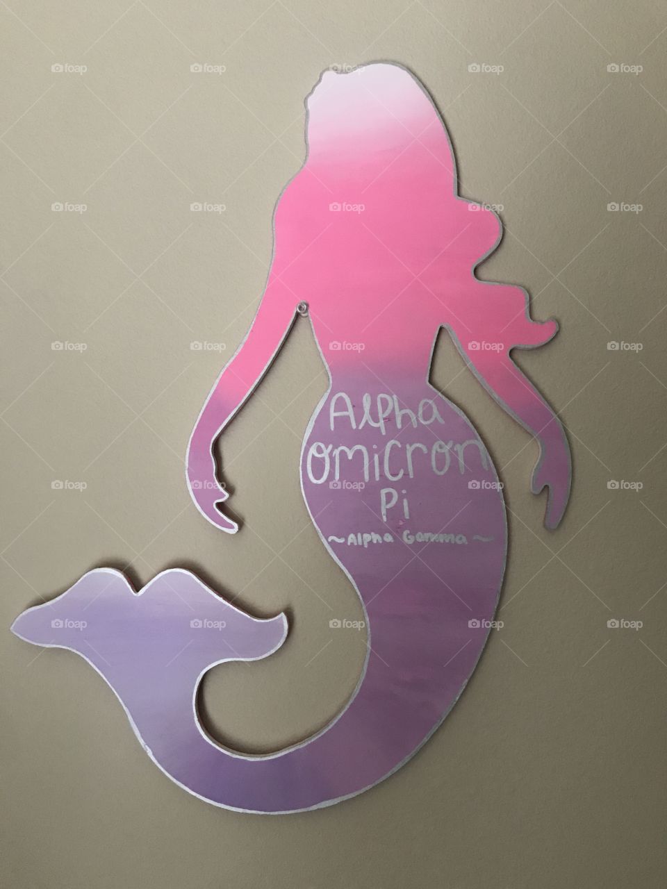 Super cute mermaid painted sign on a blank wall