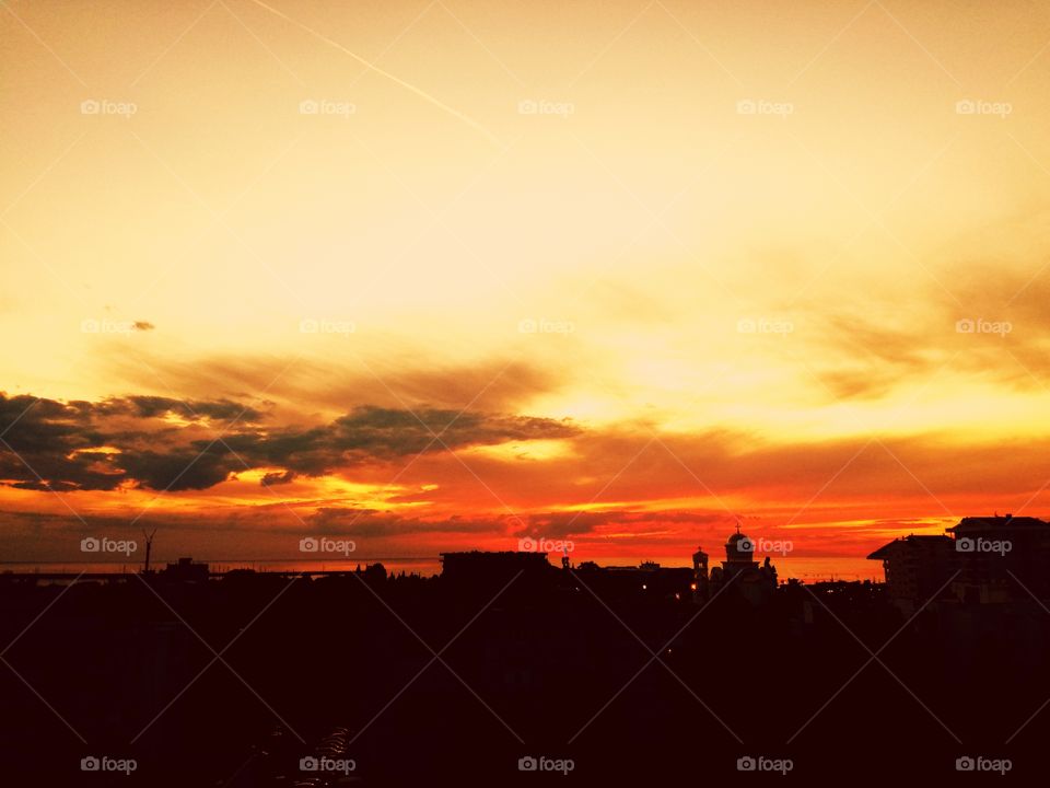 perfect orange sunset, city and sea