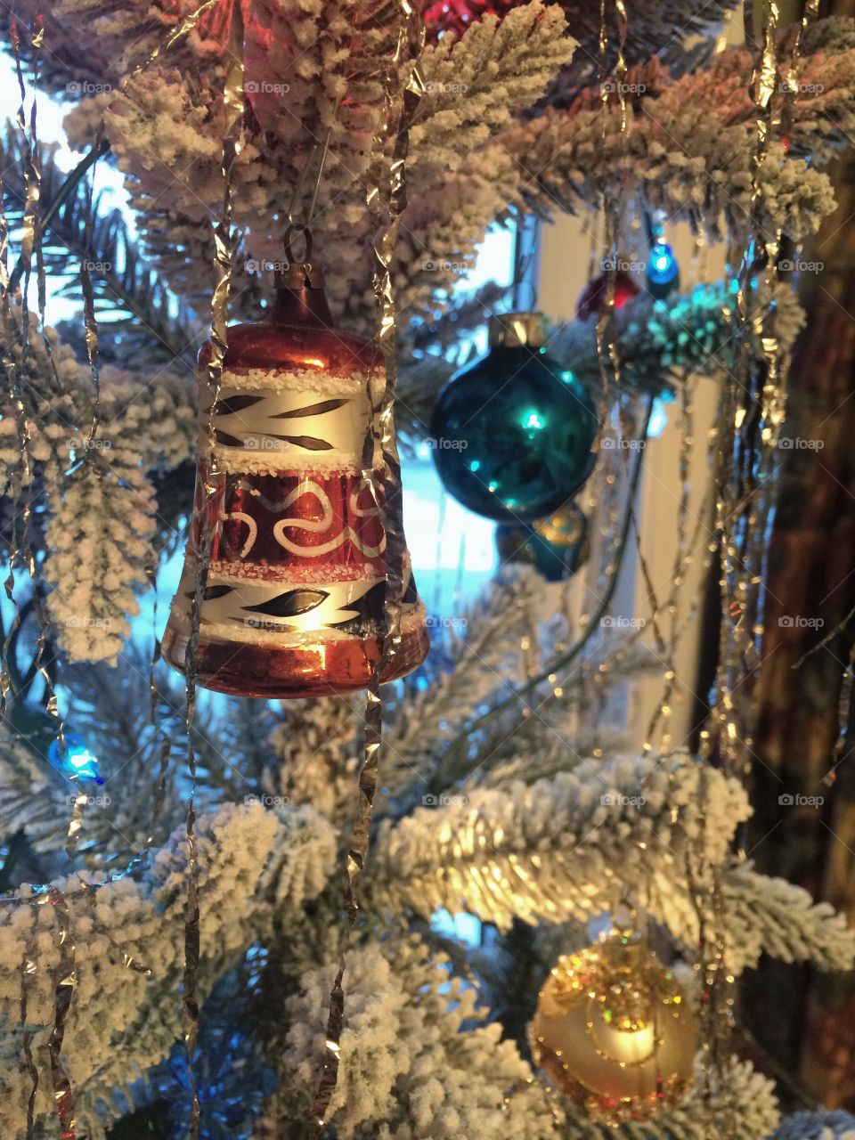 Vintage bell ornament hanging in a tree 