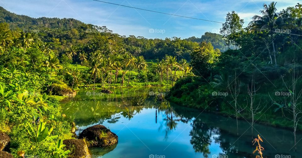 It's so naturals. Every morning and evening people usually do some activities. This is small village, it's normal and commonly doing laundry in the river areas.