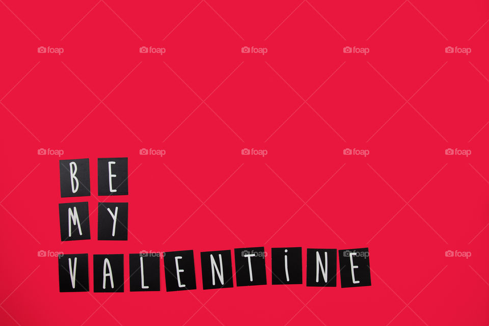 Creative concept: Valentine's Day,love and romance. Be my Valentine with alphabet letters on red background with copy space.
