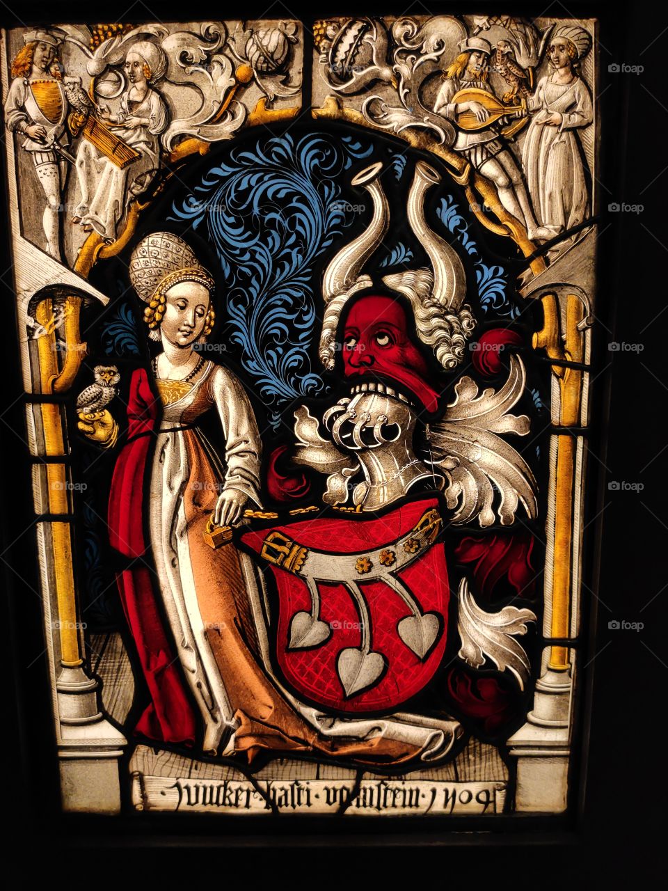 Stained glass maiden and devil
