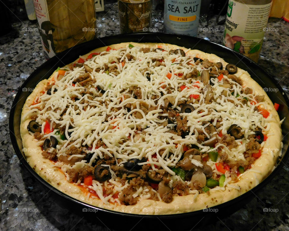 Delicious and nutritious homemade pizza with fresh, colorful vegetables, meats and a variety of spices! Grab a slice!