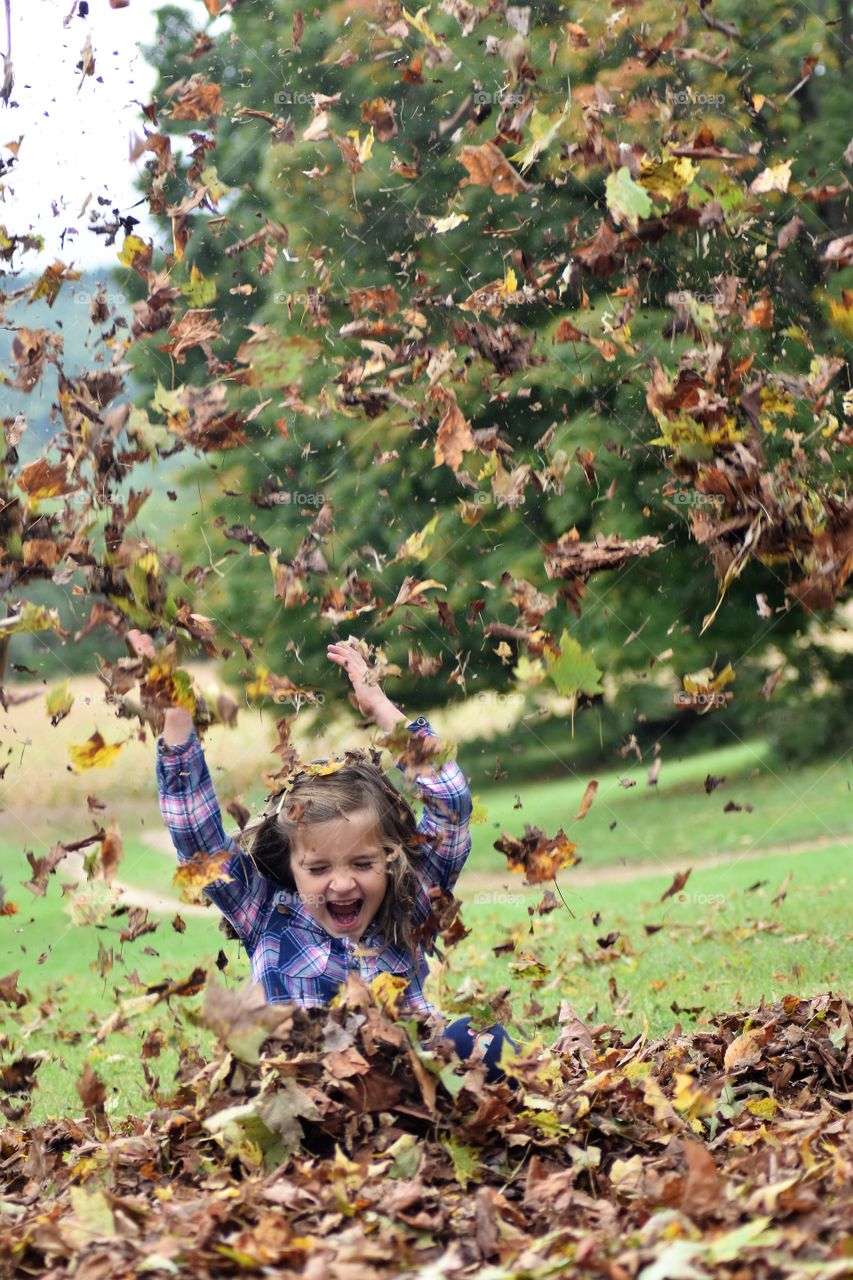 Playing in the fall leaves
