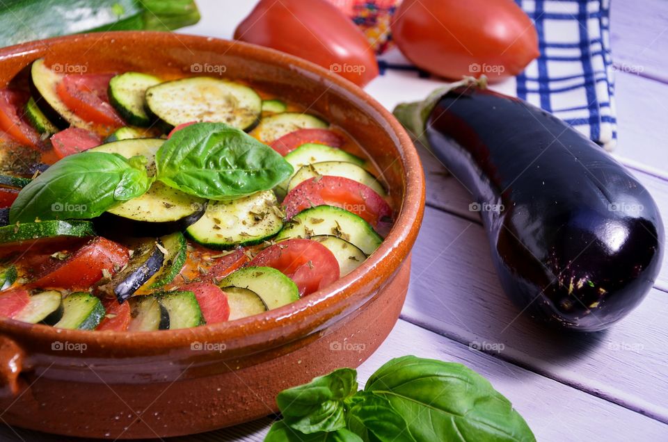 Sliced tomato and eggplant in cooking pot