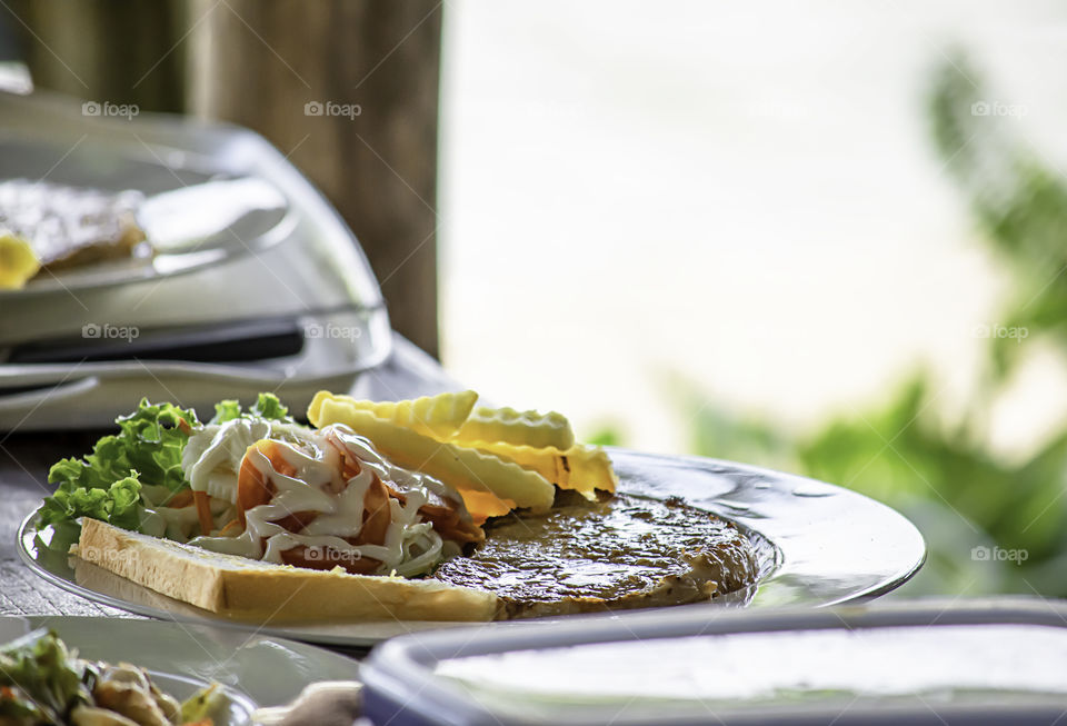 Pork steak with French fries and salad.