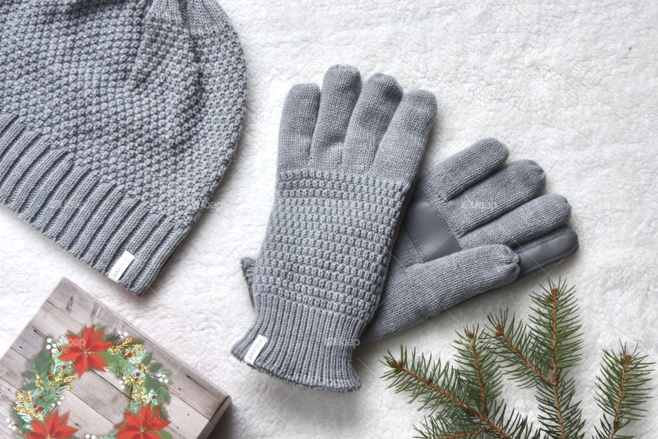 Grey Isotoner gloves in a Christmas theme flat lay still life 