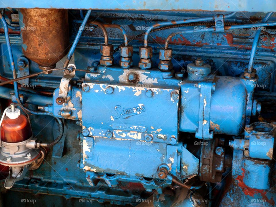 An old rusty but colorful tractor engine