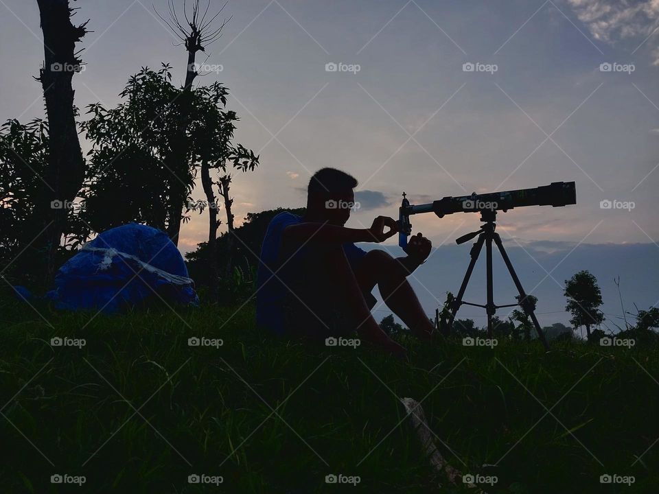 silhouette of a person taking pictures of nature