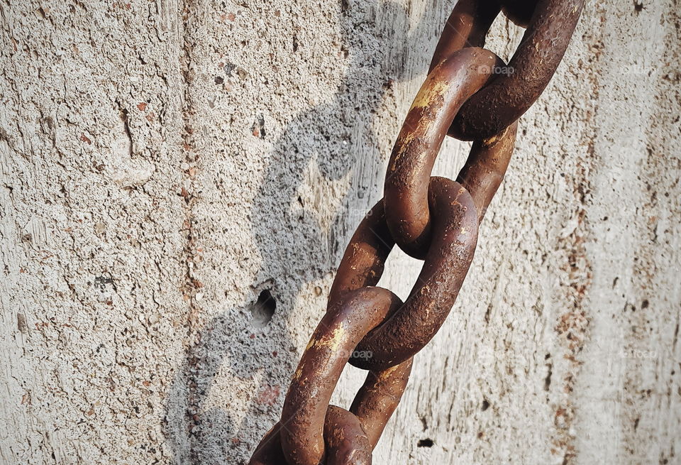 Rusty chain against concrete (landscape orientation)