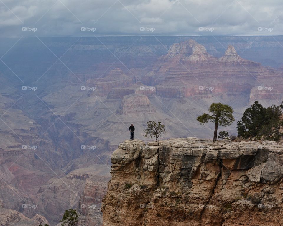 Young man standing at the edge of the Grand Canyon