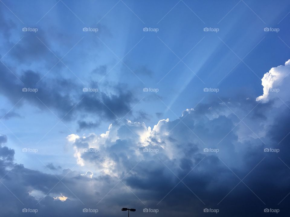 Rays of light through blue and gray clouds 