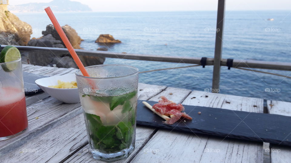 having a drink overlooking the sea