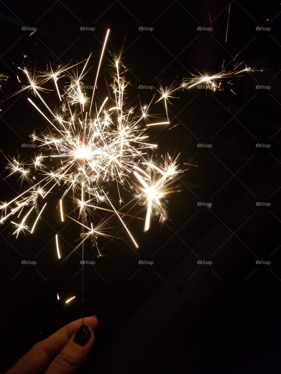 Sparks from firecrackers. Love it in the night time