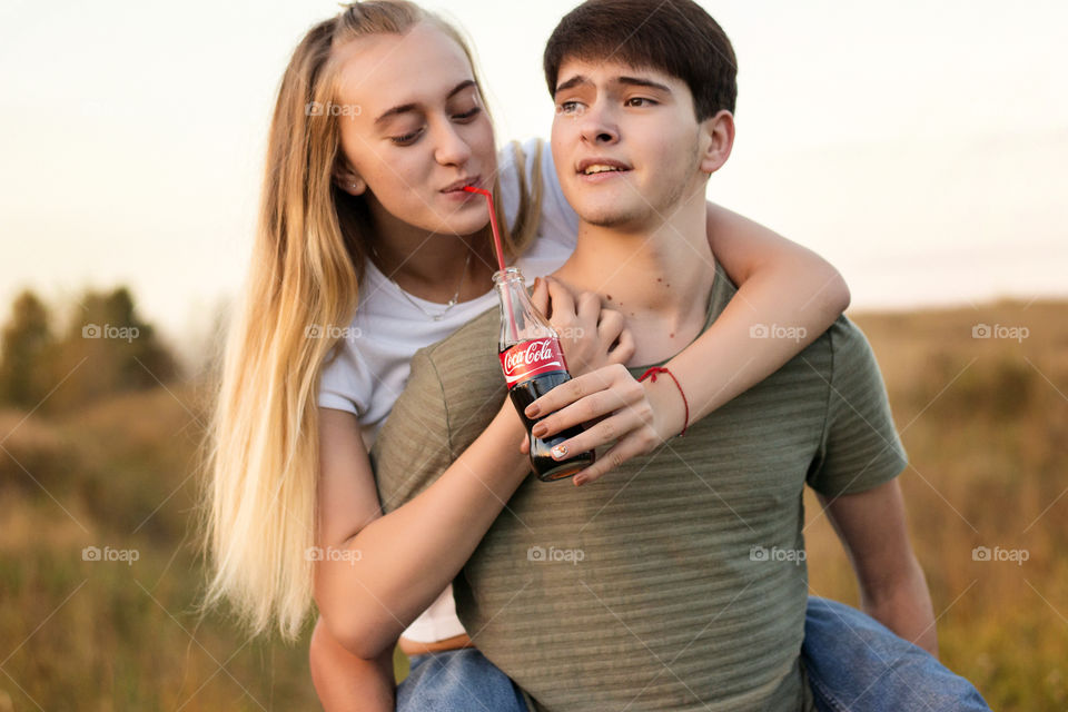 Young man giving piggy back to his girlfriend