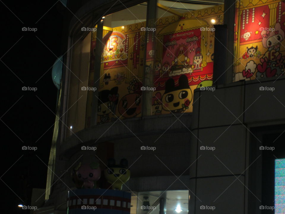 Harajuku, Tokyo, Japan. Night view of popular animated characters on shop windows.